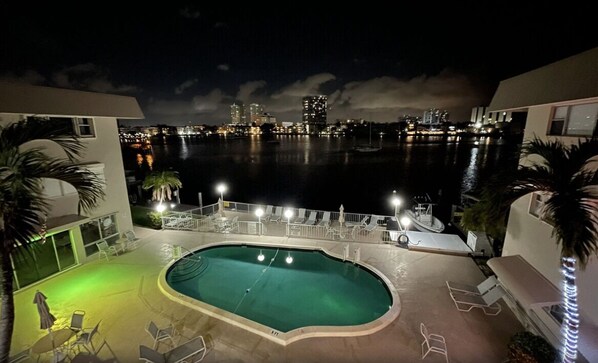 This is your view of the condo's heated pool with tables and seating. Grill too 