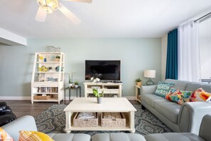 🛋️ "Relax in Style. The living area features two comfortable leather couches, a recliner, and a large smart TV—perfect for movie nights, cozy conversations, or simply unwinding after a day at