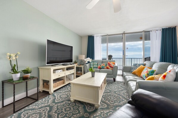 🛋️ "Relax in Style. The living area features two comfortable leather couches, a recliner, and a large smart TV—perfect for movie nights, cozy conversations, or simply unwinding after a day at