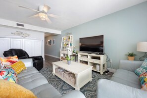 🛋️ "Relax in Style. The living area features two comfortable leather couches, a recliner, and a large smart TV—perfect for movie nights, cozy conversations, or simply unwinding after a day at