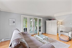 Living room leads to a screened in porch