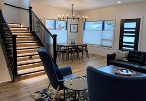 Dining area is separate from the seating in front of the fireplace.