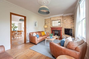 This living room with exposed brick accents serves as a welcoming and comfortable retreat