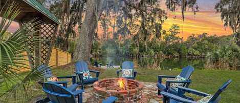 Fire pit area with water view in the main house backyard