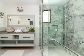 Downstairs East 
With a double vanity and double rain shower this ultra modern bathroom is tiled from floor to ceiling with marble.