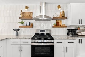 In this stunning kitchen, the white cabinets beautifully contrast with the sleek black stove. 😍✨ Get inspired to cook your favorite meals!