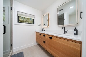 The ensuite bathroom downstairs features a double sink, shower and heated floors