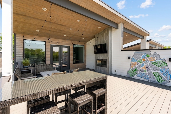 Enjoy this huge 3rd floor outdoor deck! Seating, 65" TV, lighting, gas fireplace