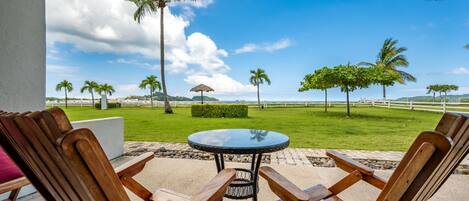 Wake up to a green view and blue waves right from your patio - Sip your morning coffee and listen to the peaceful sound of the ocean!