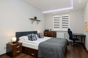An exceptional and bright bedroom with a comfortable double bed and a remote working area.