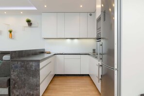 Intimate kitchenette with natural light from nearby windows.