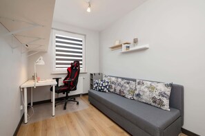 A minimalist bedroom with a sofa bed, providing a peaceful and calming retreat.