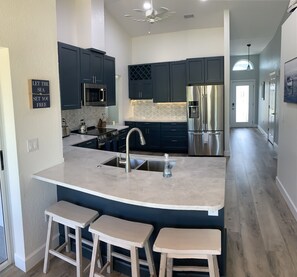 Kitchen with beautiful granite countertop seating.