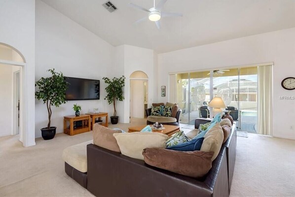 Spacious living area with cozy seating and abundant natural light for relaxing evenings.