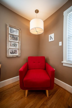 Enjoy the sitting in the red chair located in the kitchen on the first floor.