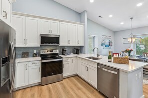 The villa features an open floor plan, seamlessly connecting the living room, dining area, and kitchen.