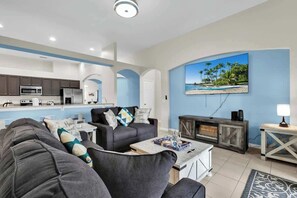 Sink into comfort in the living room oasis, featuring a plush sofa sleeper and a 75" HDTV with Roku for the ultimate entertainment experience.