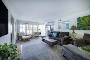 Open, airy, bright & comfy living room with convertible table, record player