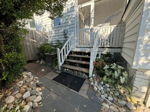 Front of beach house with screened in deck.
