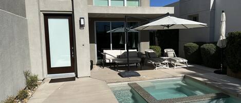 Front door, patio, pool and hot tub