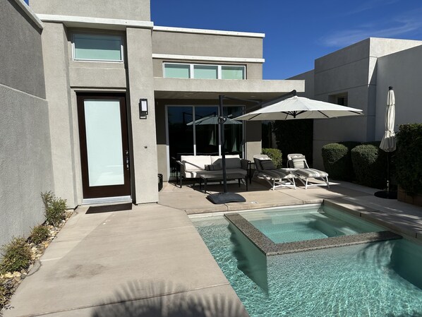 Front door, patio, pool and hot tub