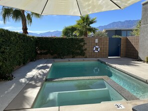 Front view of hot tub, pool and mountains