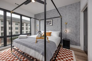 Primary Bedroom with King bed, smart TV, large walk-in closet, and en-suite bathroom.