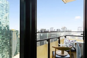 Enjoy city skyline views from the balcony. *(Balcony chairs are from the dining area).