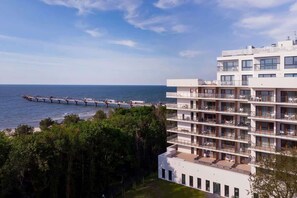 A scenic view of a coastal area with modern buildings and a stunning view of the sea.


