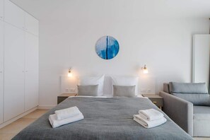 Another angle of the bedroom showcasing the bed, bedside tables, and soft lighting, creating a cozy and relaxing ambiance.
