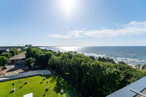 A scenic view of the sea and a lush green park, providing a tranquil and picturesque setting.
