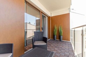 The balcony provides a perfect spot for enjoying the fresh air. 