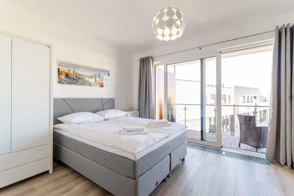 The living area features a capacious wardrobe and a flat-screen television.