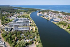 An aerial view of a scenic area with greenery, and a residential complex.
