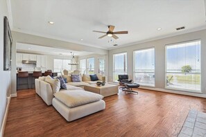 With plenty of natural light, a dedicated bar area, and two oversized plush couches for your lounging comfort, this spacious living room is one that you can sit back and relax in!