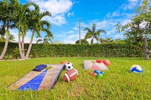 Enjoy a game of corn hole or a variety of sports with a spacious lawn