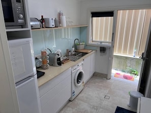 Kitchen and Private Entrance to the Studio including large Fridge and Washing Machine