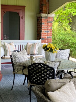 Covered veranda, porch swing.