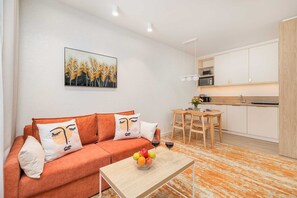 Living room with television and dining area.