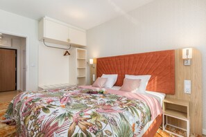 Cosy bedroom with double bed and cabinets.