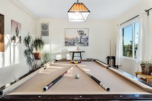 Enjoy a game of pool in this bright and cheery room.