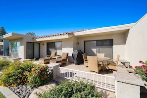 Extended patio with 180 degree mountain views. Plenty of sitting space, BBQ and steps away to the pool.