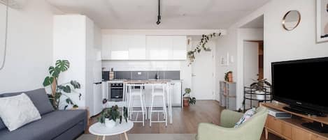 The living area evokes a calming vibe, brimming with greenery and natural light.  