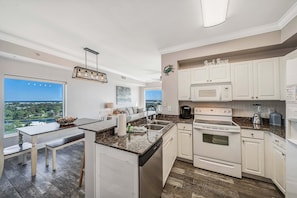 The fully equipped kitchen features granite countertops and has everything you need to prepare your meals.