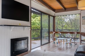 Settle into a cosy reading nook with the sliding doors wide open, welcoming in the refreshing breeze. Children have their own chair and table, and you can also enjoy the fireplace for extra warmth.