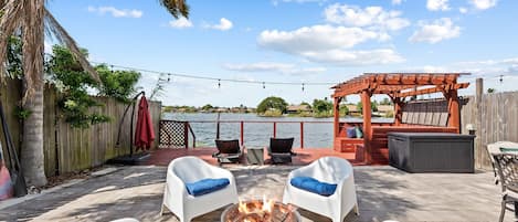 Outdoors featuring Patio with firepit, sun loungers, cabana, and hot tub