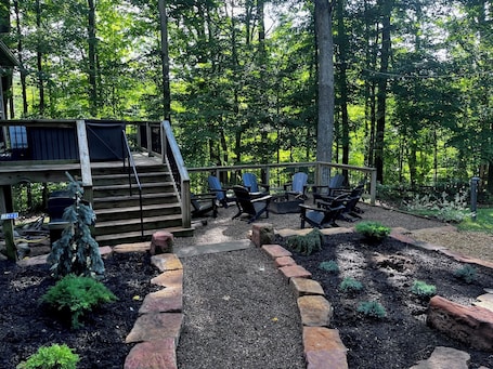 The peaceful outdoor setting at Pine Lane cannot be beat! Surrounded by woods Pine Lane offers a fire pit, lawn for playing, gas grill, hot tub, and covered porch/living area,