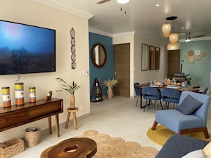 Enter our inviting living room featuring a 65-inch TV, a luxurious sofa bed.