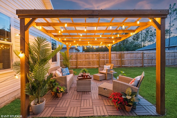 After a long day at the beach, unwind under the pergola with friends and family.