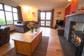 Low Howe Cottage in Coniston sitting room with log burner